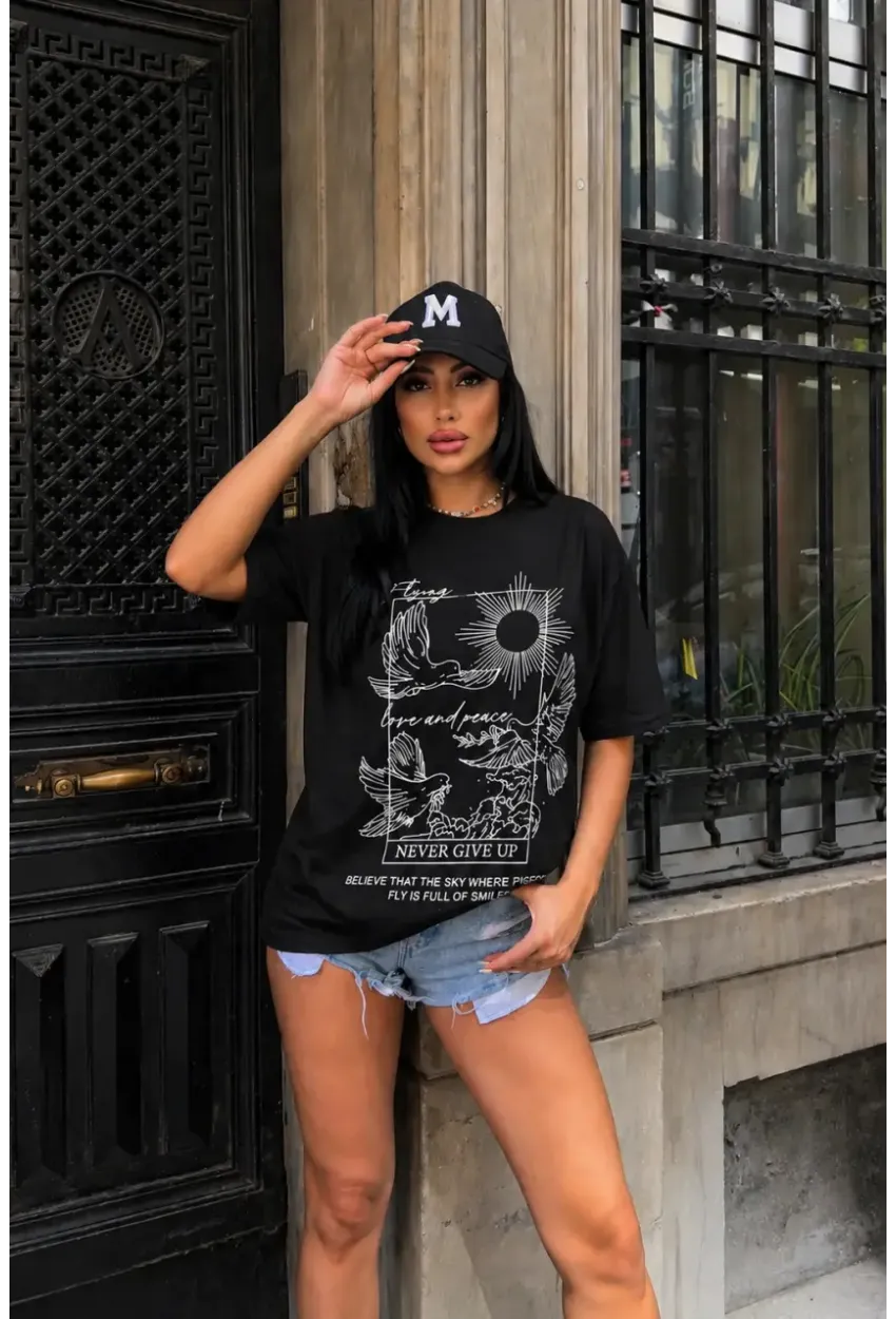 Siyah Güvercin ve Güneş Baskılı Oversize Penye T-Shirt – “Never Give Up” Yazılı Minimal Tasarım